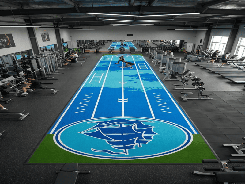 Worker cutting out a damaged section of turf for repair